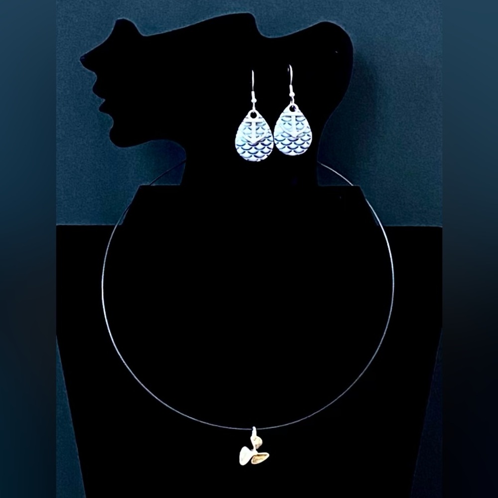 Earrings with anchors on them and  a necklace with a propeller charm set